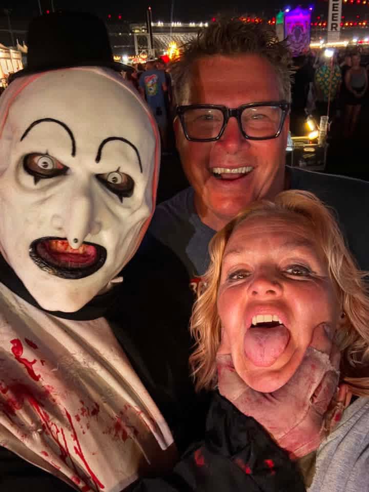 Night selfie: Art the Clown choking a laughing woman next to her friend