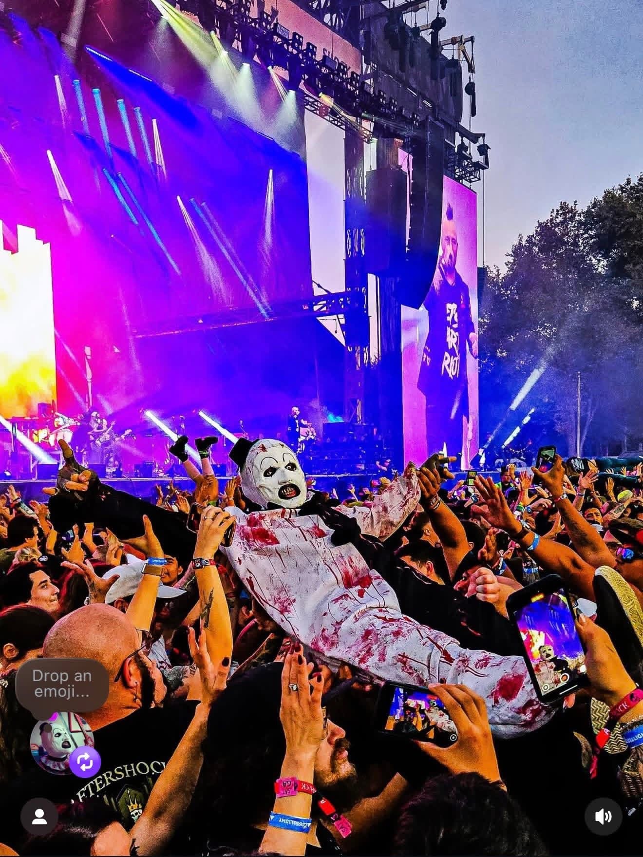 Art the Clown crowd surfing over the hands of a festival audience