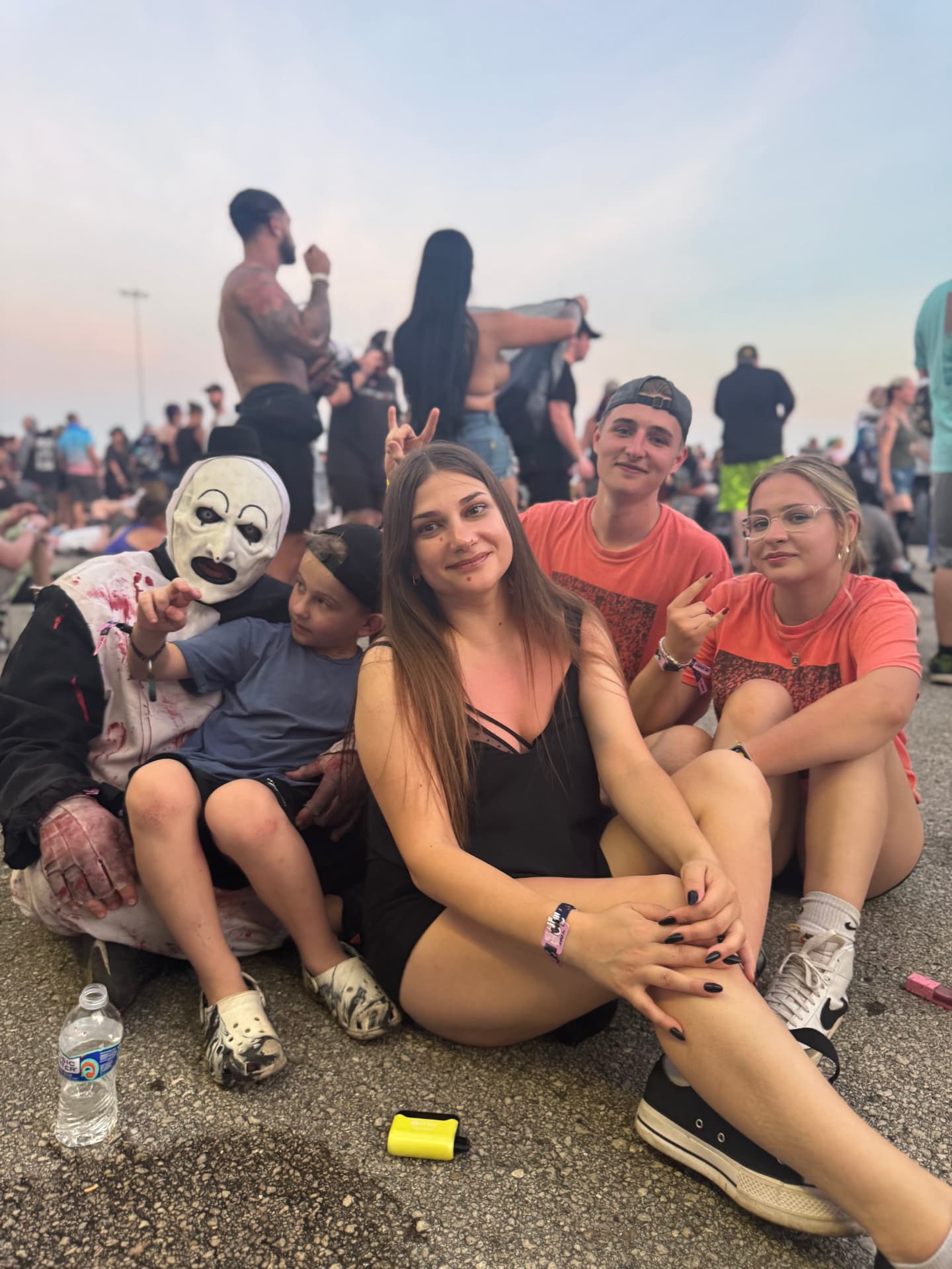 Aleksandr in costume sitting with his family and friends at the festival