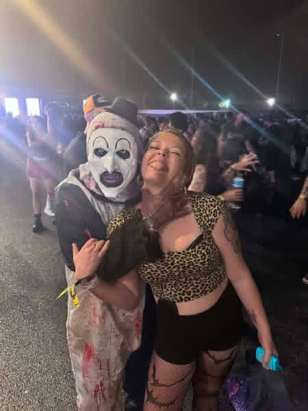Night crowd: Art the Clown hugging a laughing fan in leopard print