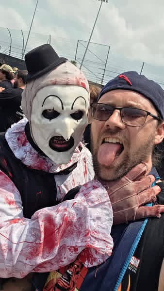 Daytime selfie: Art the Clown choking a laughing fan in sunglasses