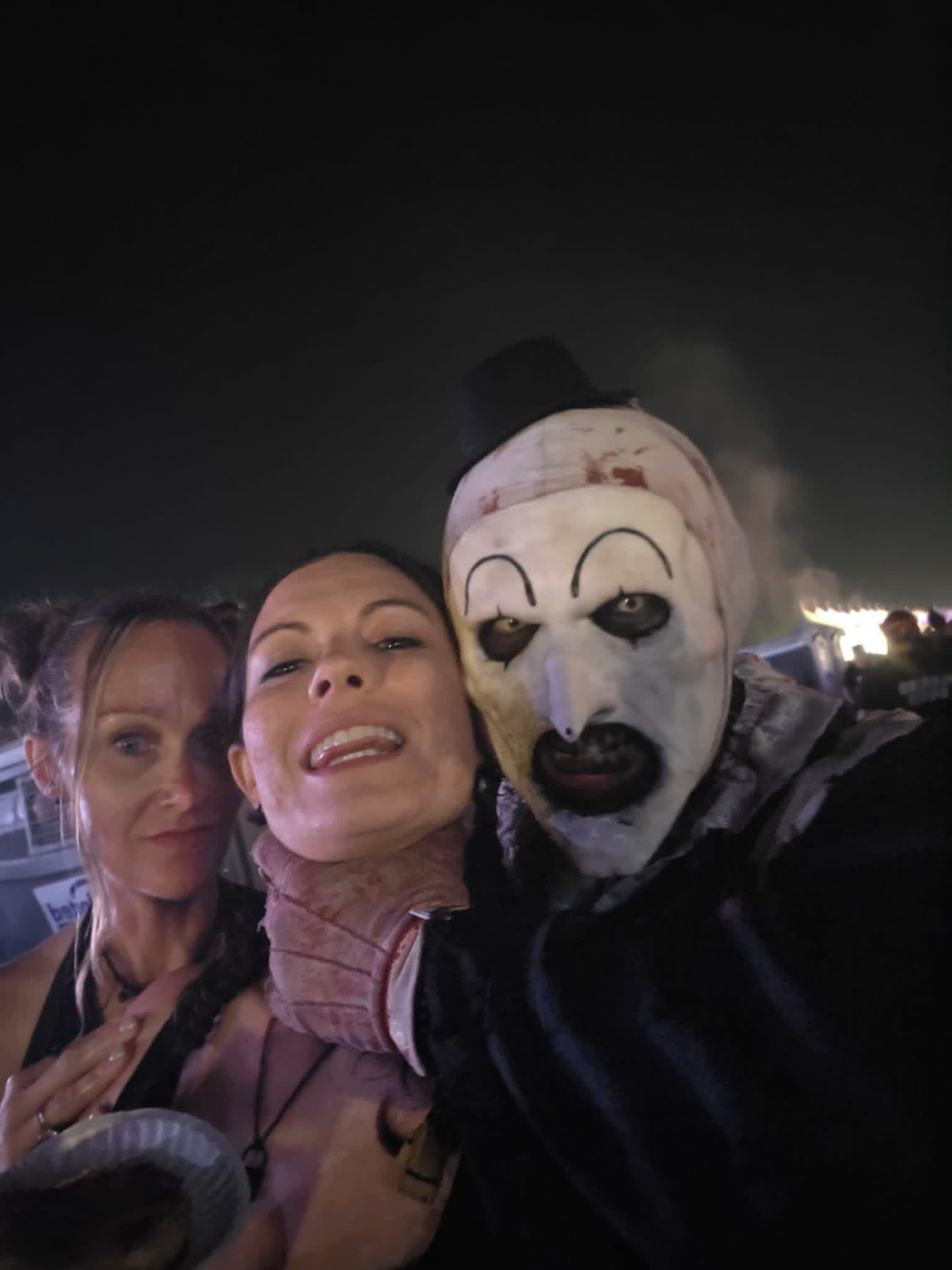 Night selfie: Art the Clown with two fans in the crowd