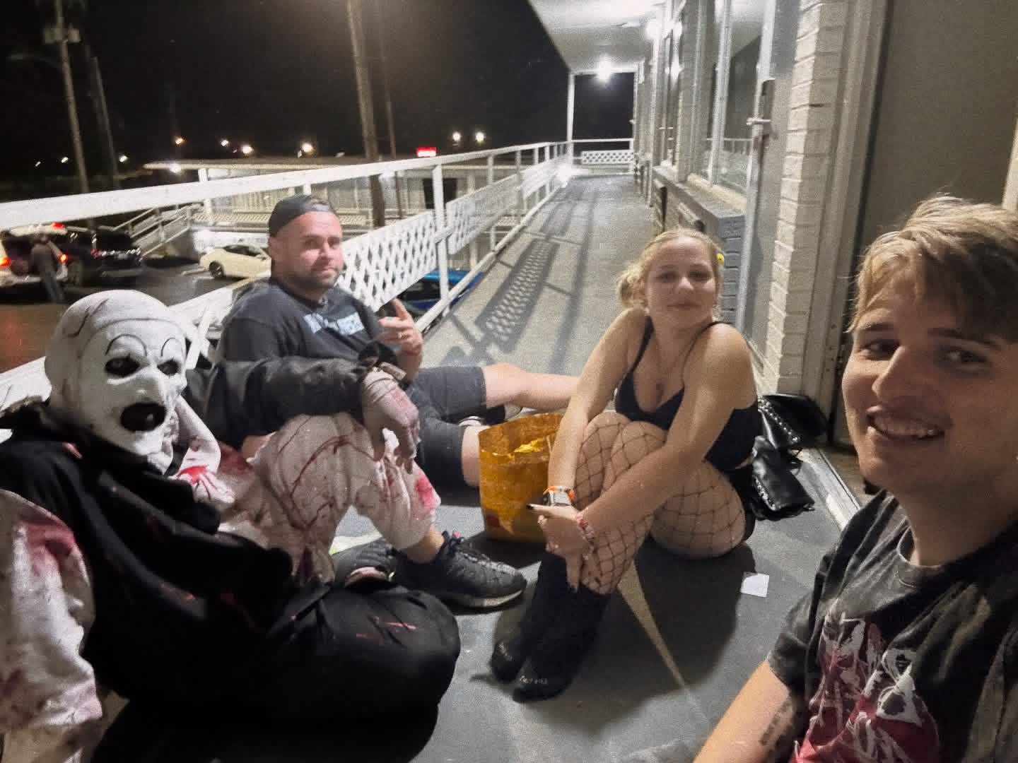 Aleksandr sitting outside at night with friends after a festival day