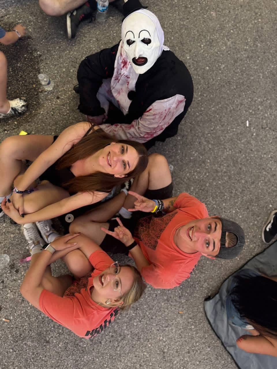 Aleksandr sitting on the ground with three friends
