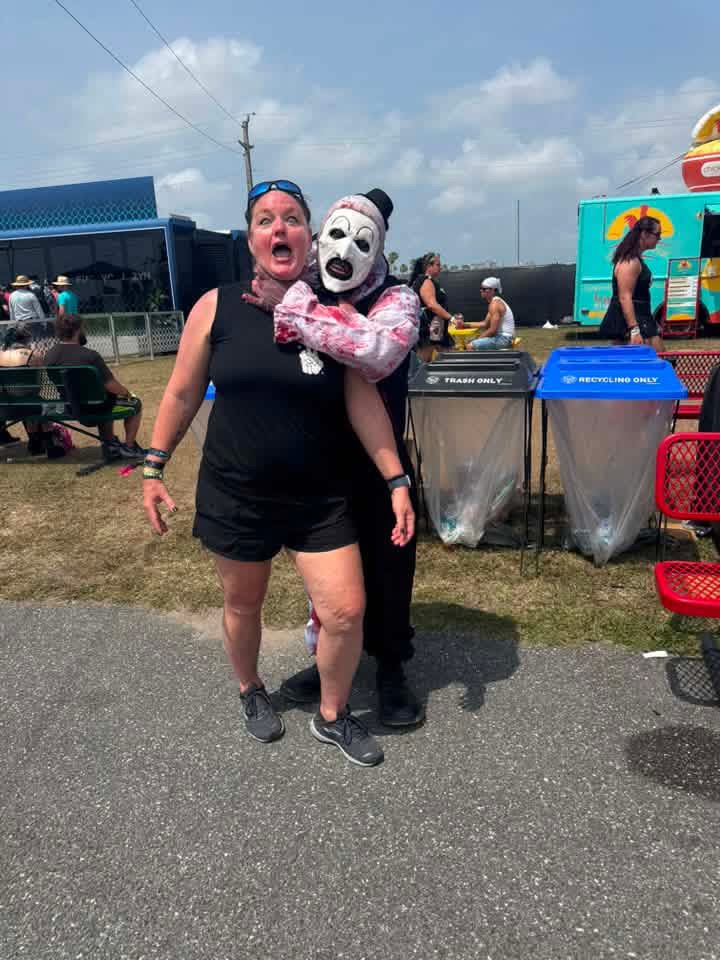 Art the Clown choking a screaming fan for a joke photo by the food trucks