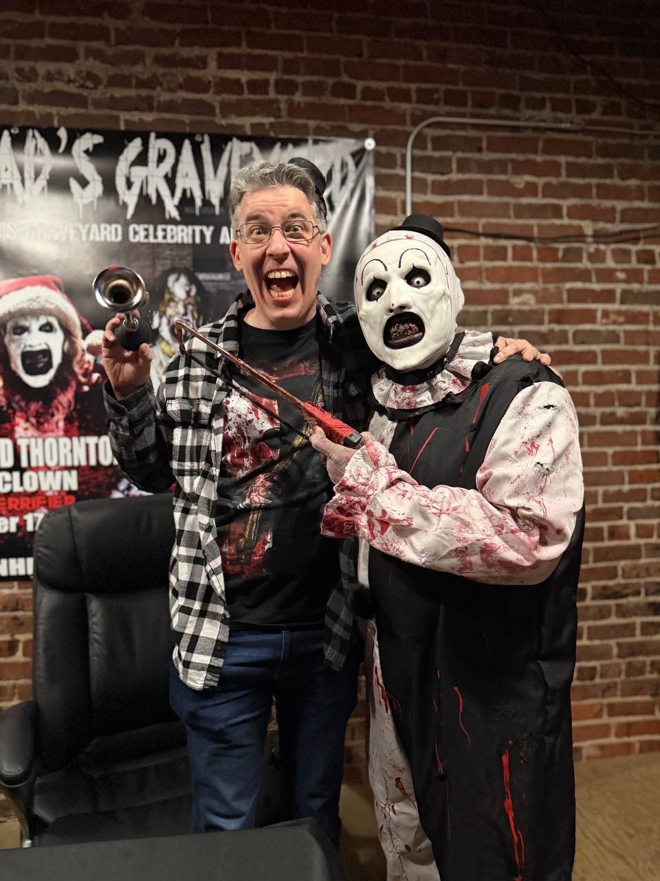 Aleksandr in costume posing with a horror convention guest