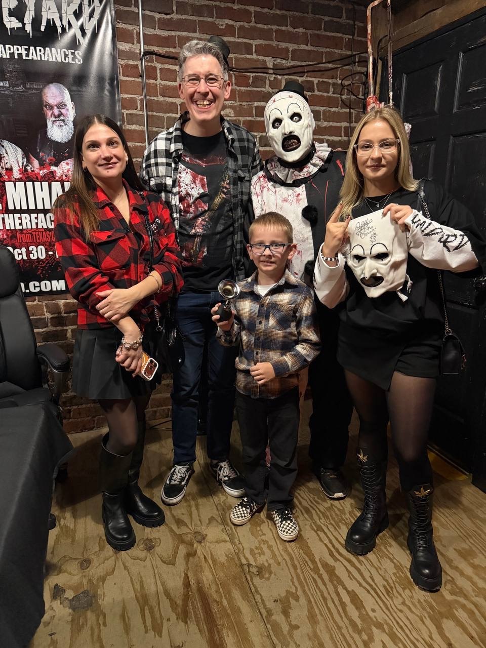 Aleksandr in costume with his family and a guest at a horror convention
