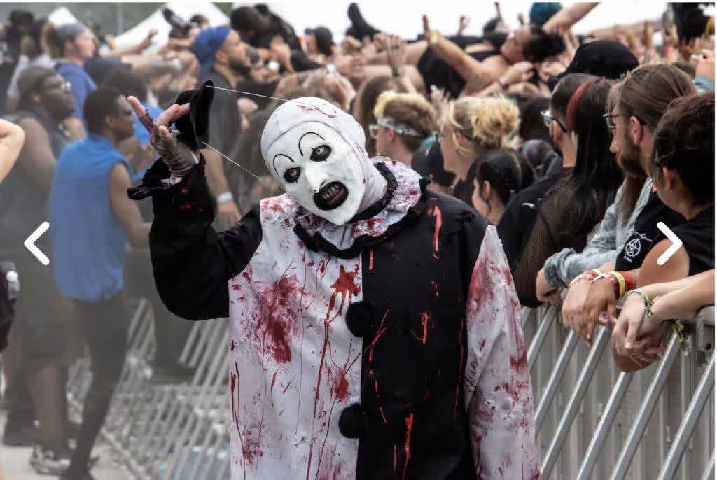 Art the Clown tipping his hat in front of the barricade crowd