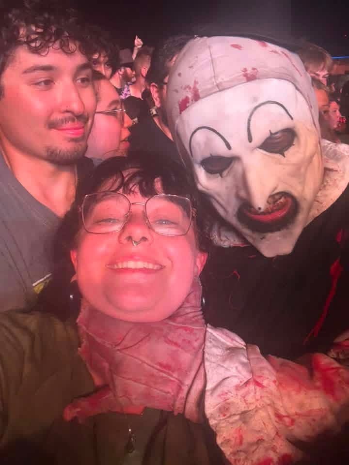 Packed crowd selfie: Art the Clown squeezing in with three fans